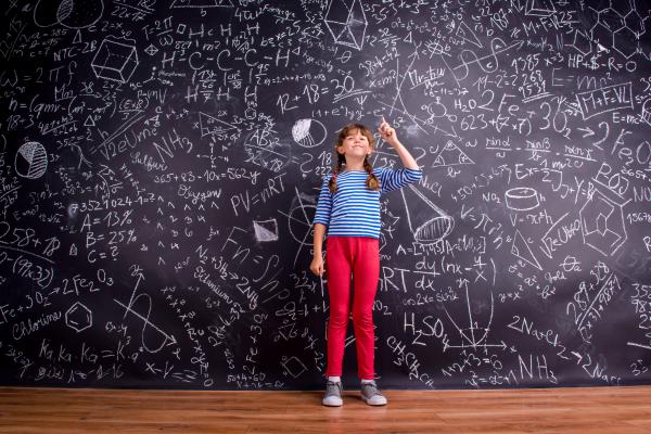 Photo of a young girl in front of a blackboard by Halfpoint, courtesy of Getty Images.