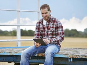 New Tool Offers Insights into Global Climate Patterns. NIFA Impact story. Image of farmer holding electronic device, courtesy of iStock photos.