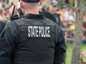 Police Officer Duty Gear Carriage Improvements. Fresh from the Field Impact, editor Falita Liles. Photo of a State Police Officer wearing a protective vest courtesy of Unsplash.
