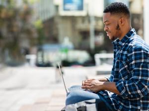 Male College Student with Laptop, courtesy of Getty Images